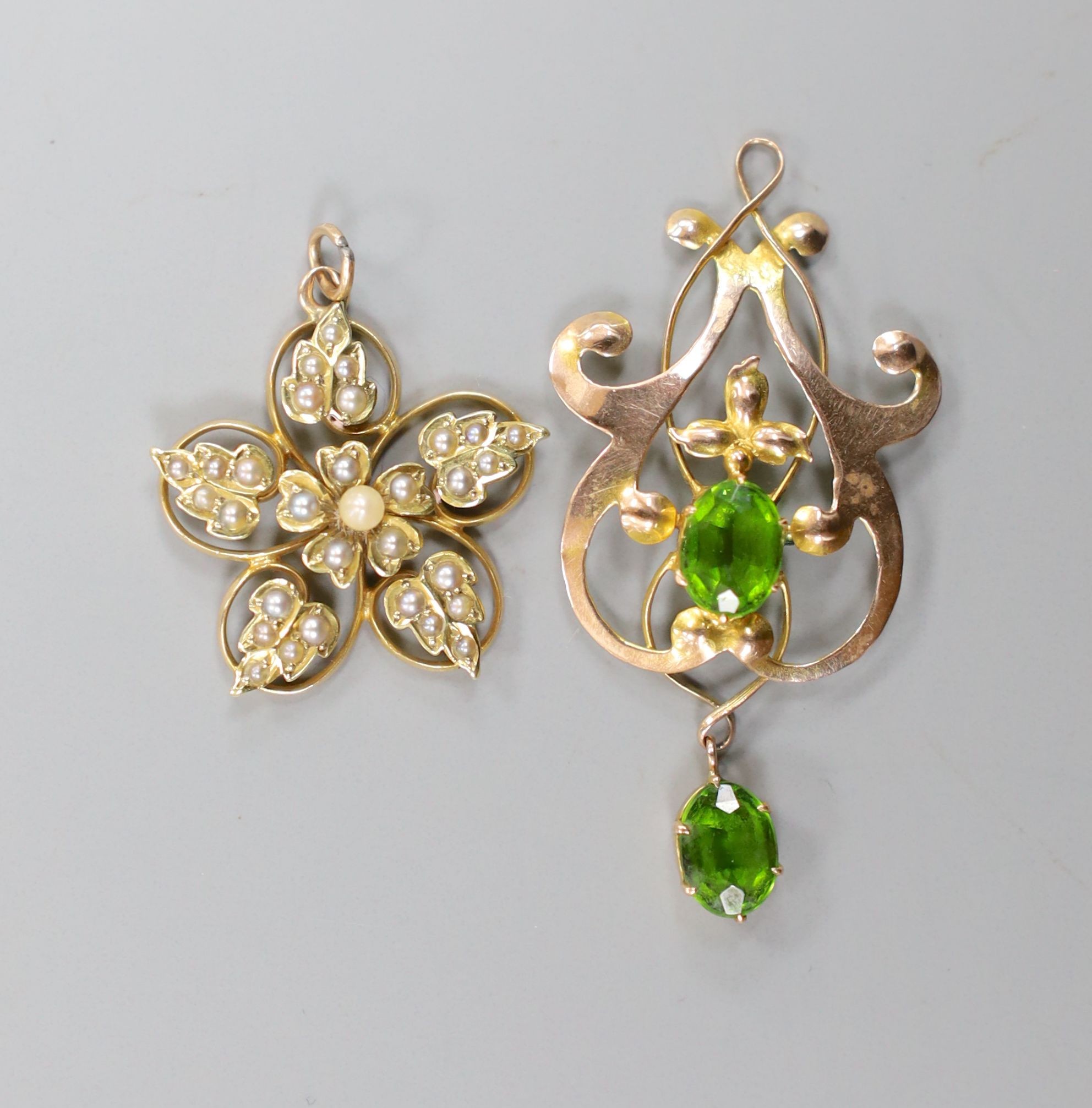 An early 20th century 9ct and green stone doublet set drop pendant, 41mm, gross 2 grams and a 15ct and seed pearl set pendant, gross 2.7 grams.